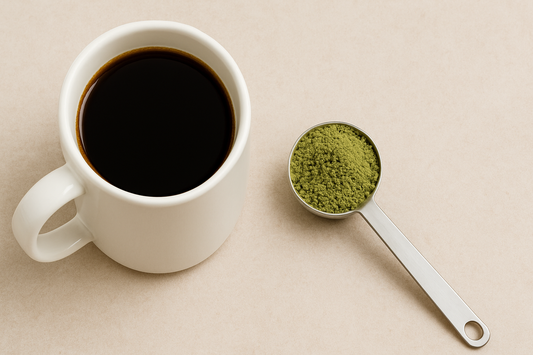 Image of a coffee mug with a spoon of kratom powder next to it.