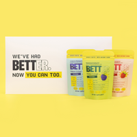 Three yellow drink pouches beside a white sign reading "WE'VE HAD BETTER. NOW YOU CAN TOO." One pouch shows large text BET.