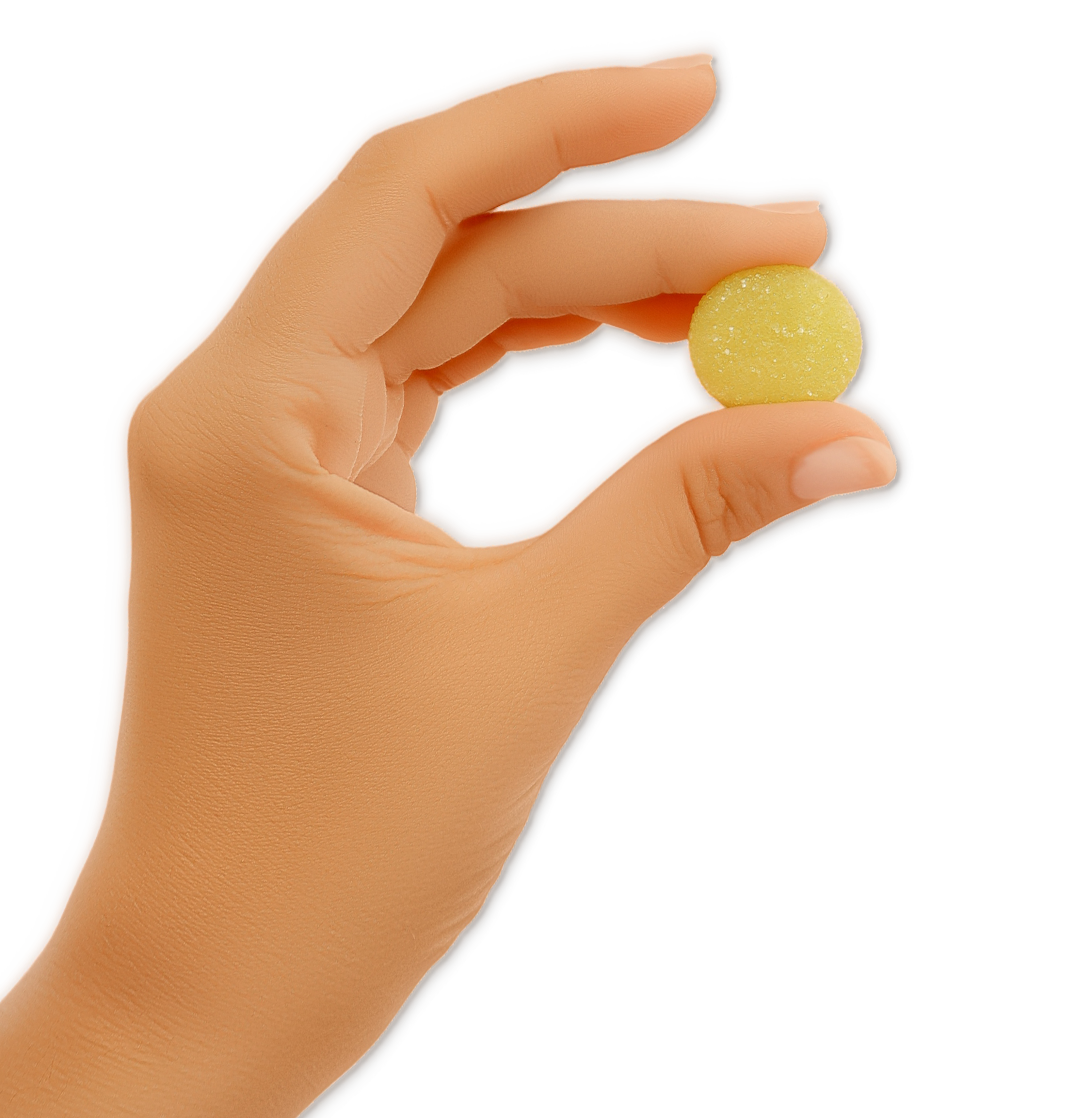 Hand holding a small round yellow sugar-coated candy between thumb and forefinger on black background.